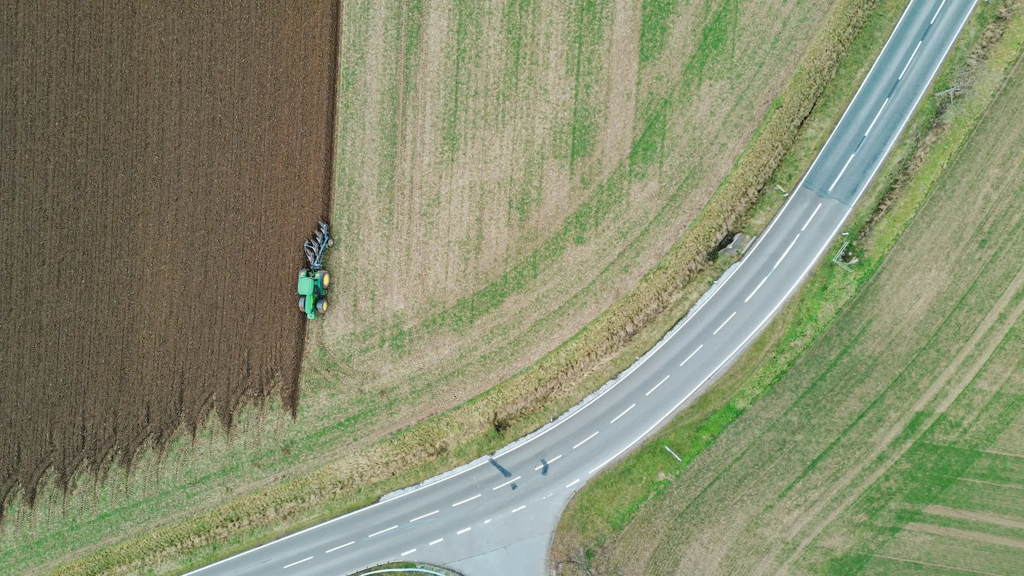 Aerial view of a country road with a tractor