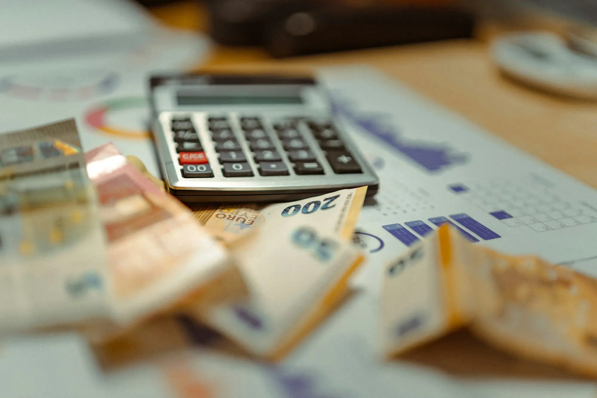Calculator sitting on a pile of cash