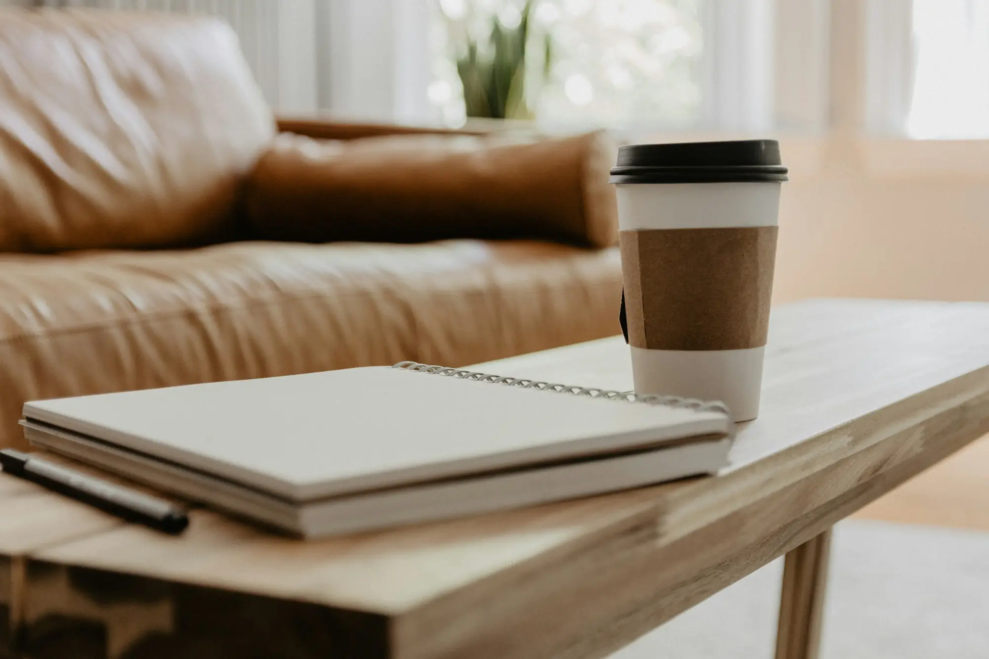 Coffee cup on an open notebook
