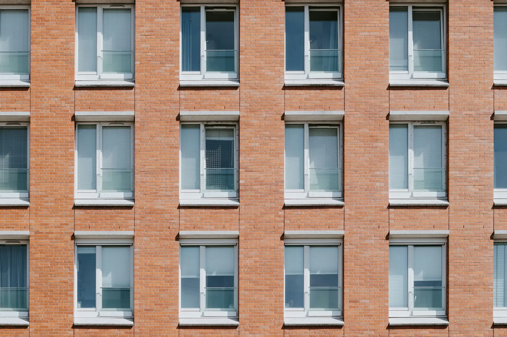 Red brick building facade with rows of windows