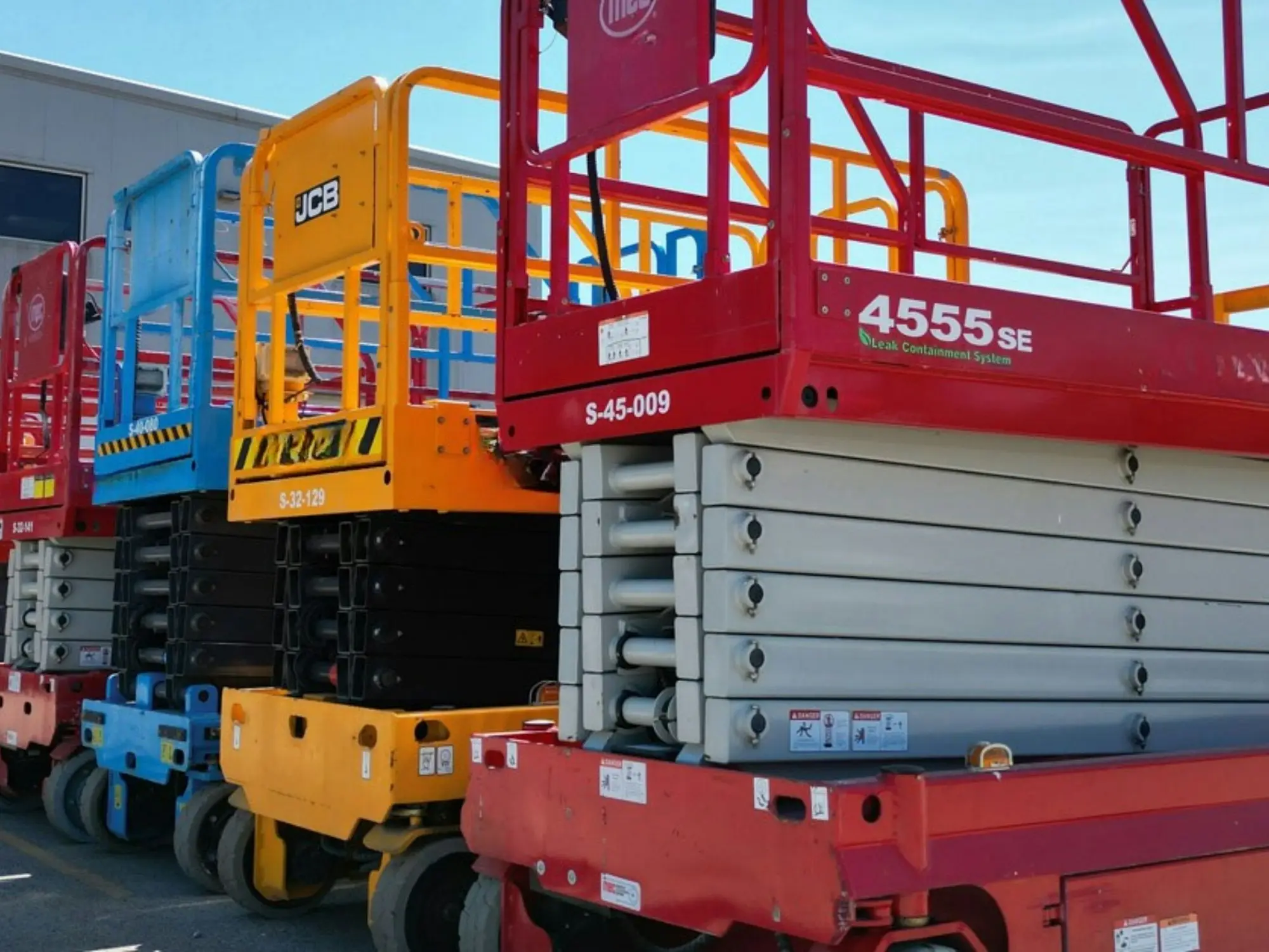 Row of scissor lifts parked