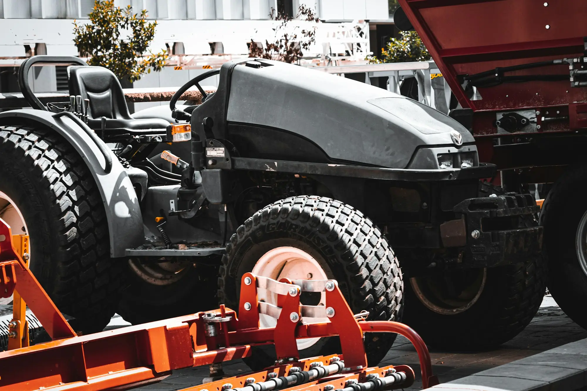 Red tipper trucks parked side by side